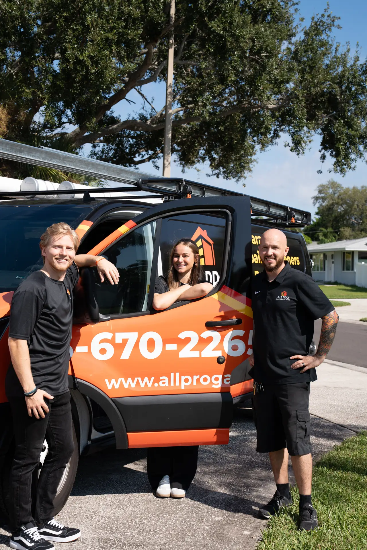 The All Pro Garage Doors team with their service van